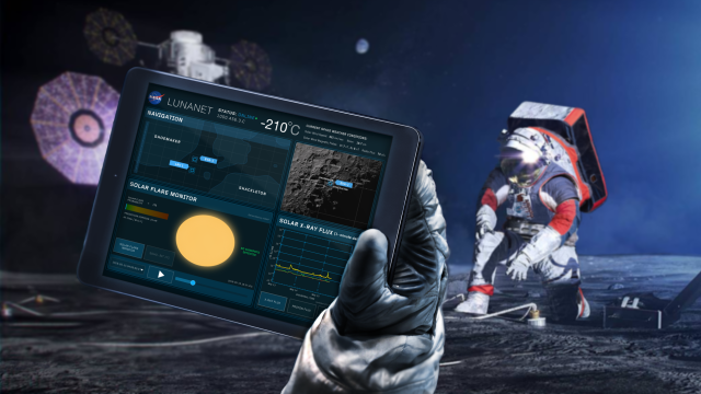 An artist's rendering depicts two astronauts on the Moon's surface. In the left foreground, a gloved astronaut hand holds a navigation device. To the right, an astronaut kneels on the lunar surface. In the background, a spacecraft sits on the Moon’s surface, partially hidden by the navigation device in the foreground. A very pale blue dot, Earth, sits in the middle of a dark blue sky. Credit: NASA/Reese Patillo