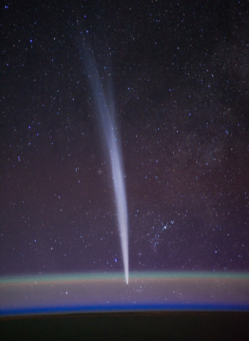 humanoidhistory: Comet Lovejoy shooting through space, visible near Earth’s horizon in a night
