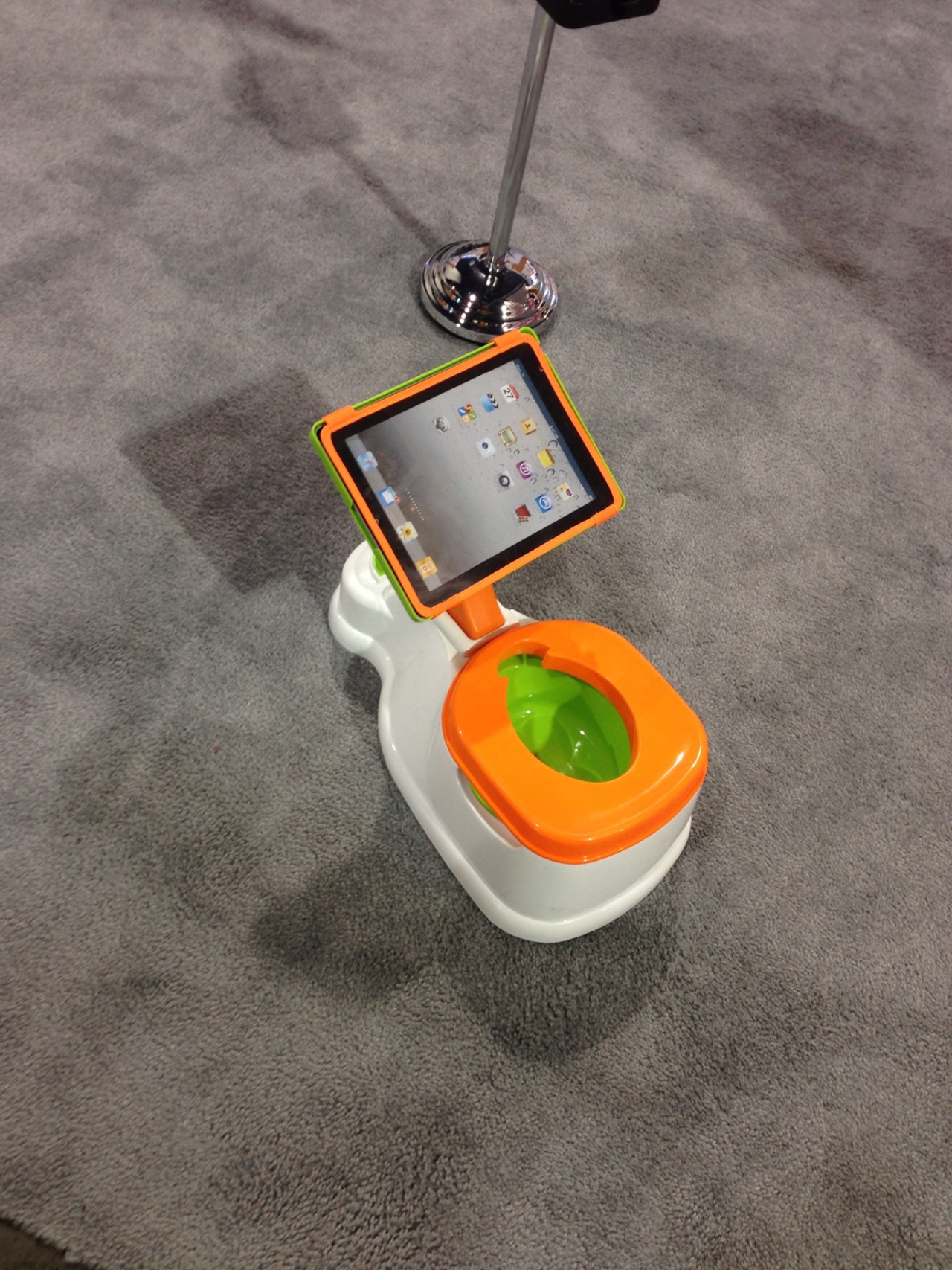 Spotted at CES 2014: iPotty is the training toilet with a holder for an iPad.
Also good for teaching kids how to sit on the toilet backwards. Photo by IHCer DigiDiva.