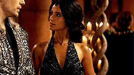 Maya, Adjusting The Delicate Folds Of Her Gown, Let Out A Soft Sigh As She Entered The Dimly Lit Hall.