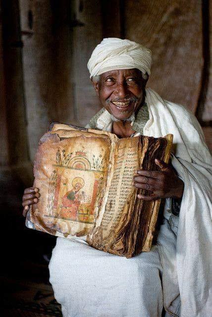 Ethiopian priest on Lake Tana with an 800 years old goatskin bible.