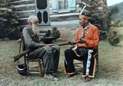 lndisher:  Tennessee - An Appalachian man converses with an Indian in front of a log cabin, Great Smoky Mountains, Near Gatlinburg 1920s-1930s 