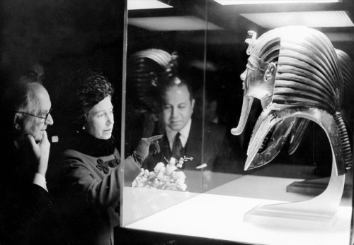 Queen Elizabeth II looks at the mask of King Tutankhamun. The Queen officially opened the exhibition