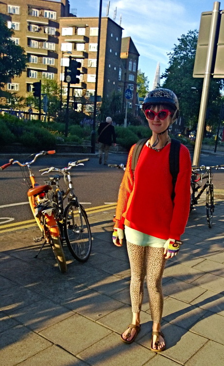 suomigirl: Check out this girl, matching leopard patterned leggings and a helmet. Cool orange bicycl