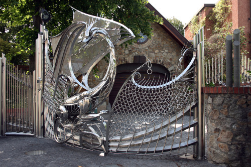 hideback:  Dragon’s Gate, Harlech House Goatstown, Dublin, Ireland. Curved Stainless Steel with Glass Eyes. Started circa 1993. Harlech House is a 7-bedroom estate built in 1798. Incredibly elaborate steel ornaments adorn the entire property, including