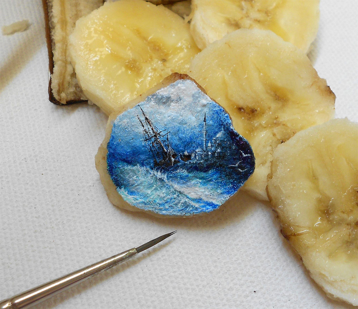 Tiny landscapes painted on food by Kasan Kale.