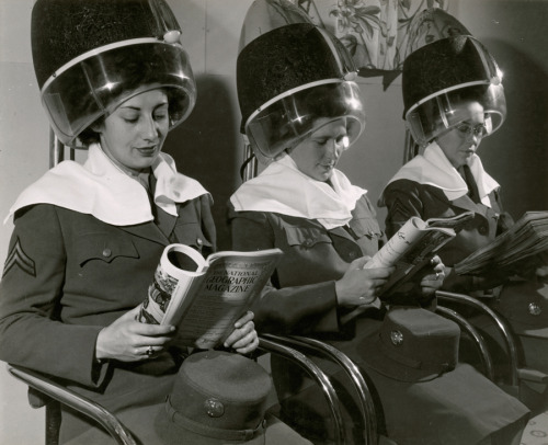 Servicewomen read National Geographic Magazine at a beauty parlor in Illinois.Photograph by Luis Mar