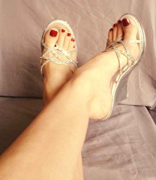 Sexy clear, heeled, strappy thong sandals on pretty feet.