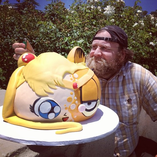 sweetappletea:  remissionette:  Here, have a picture of Pen with a Sailor Moon/Garfield cake holding a cigarette lighter while staring wistfully off into the distance.  This is the creator of Adventure Time everyone. 