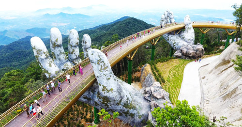 itscolossal:Vietnam’s Newly Opened Pedestrian Bridge Lifts Visitors with a Pair of Giant Weath