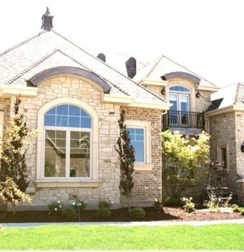 Roofing SacramentoLarge Elegant Beige Two-story Stone House Exterior Photo With A Hip Roof And A Shingle