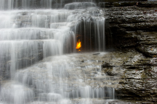 sixpenceee:  Eternal Flame Falls The Eternal Flame Falls is a small waterfall located in the Shale Creek Preserve, a section of Chestnut Ridge Park in Western New York. A small grotto at the waterfall’s base emits natural gas, which can be lit to produce