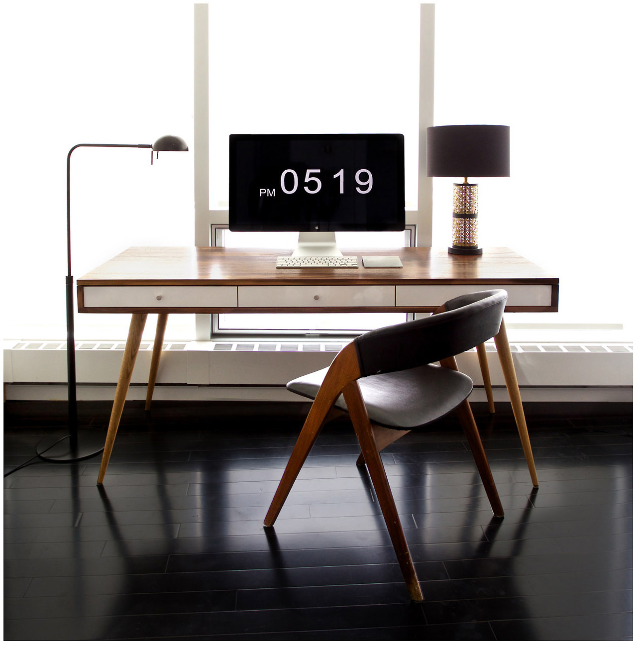 Reader, ernesthon, submitted his desk. This is just beautiful mid-century example of an elegant, minimal workspace.
“ The desk was custom made with American Black Walnut in San Francisco. The chair is vintage teak from Norway. The table lamp is also...