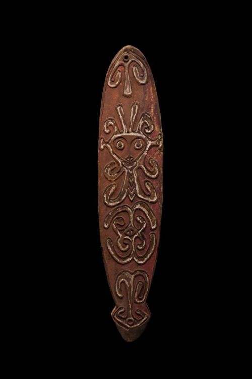 Gope board probably from the Era River area of the Papuan Gulf. The backside has the deep adze marks