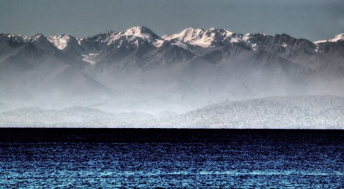 Why are there mountains here?This photograph shows part of the front range of the Tian Shan Mountain