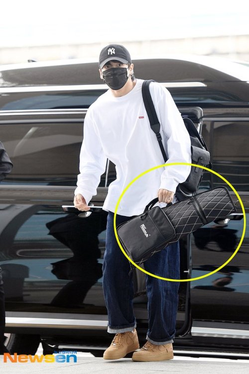 jung-koook: jungkook carrying a drumstick bag