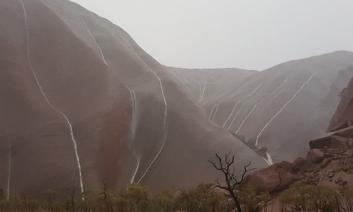 A rare rainfallUluru, that grand tan sandstone monolith gracing the desert wastes of Central Austral
