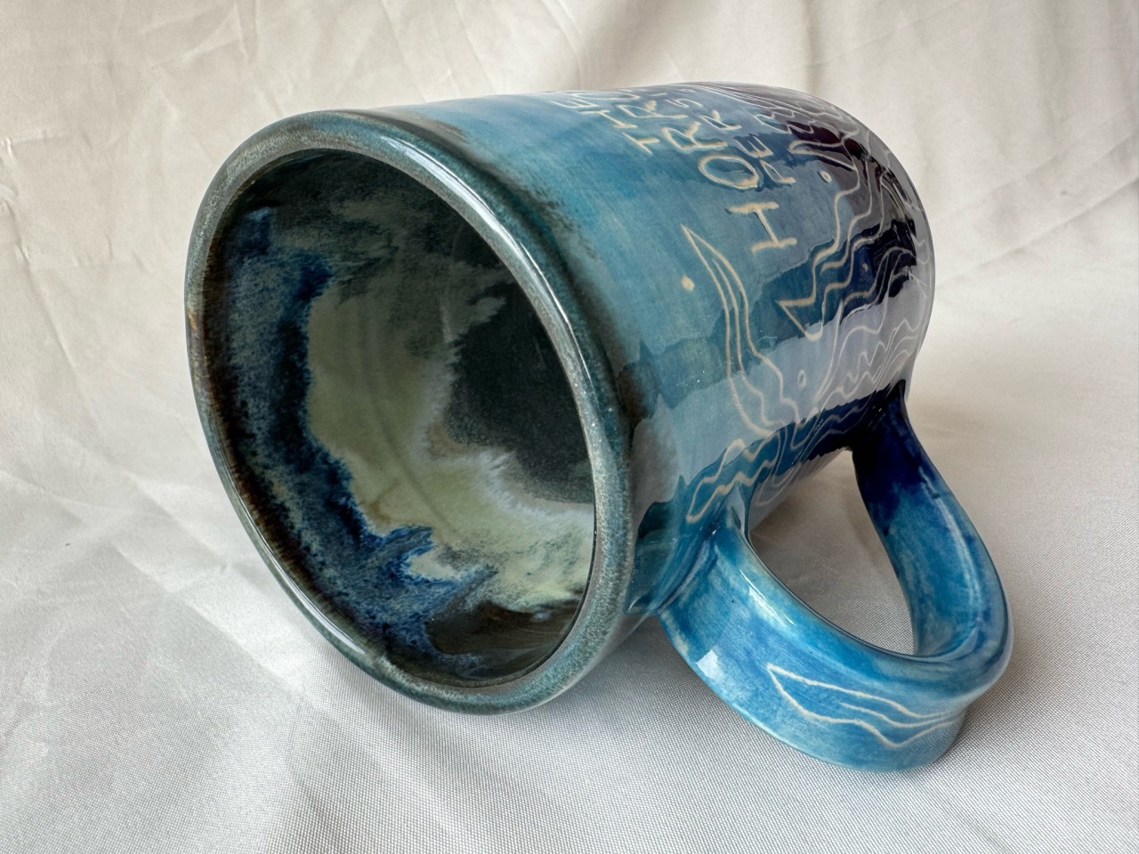 the inside of the mug. it was glazed in blues and greens