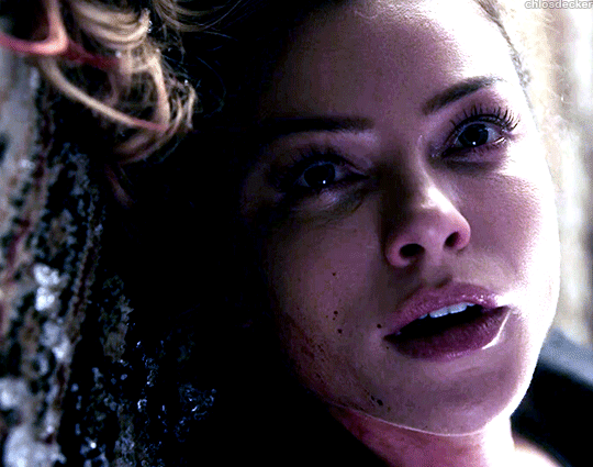 A closeup gif of Chloe Decker from Lucifer. She lies on the ground looking at Lucifer, offscreen. A single tear falls down her face.