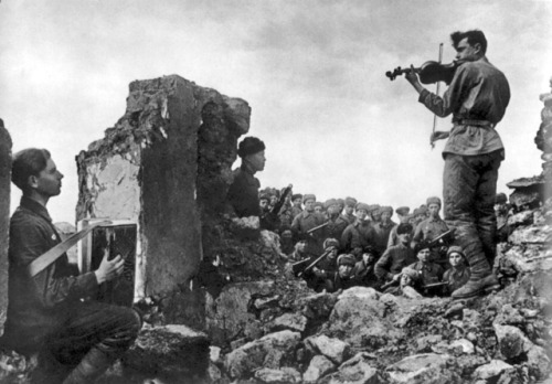 historicaltimes: Soviet soldiers play a nocturne for their comrades amidst the ruins of battle. Novo