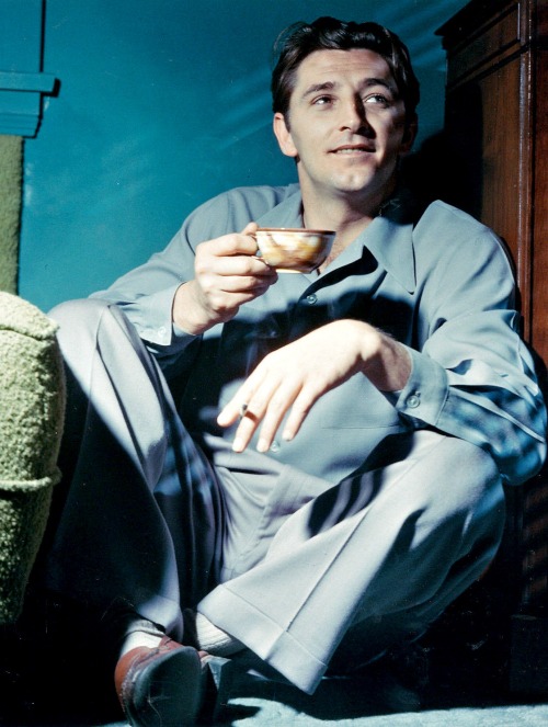 robert-mitchum: Robert Mitchum enjoys a cigarette and some tea, c. 1940s