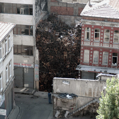 Doris Salcedo (Colombian, b. 1958, Bogotá, Colombia) - Installation of 1,550 chairs evoking the mass