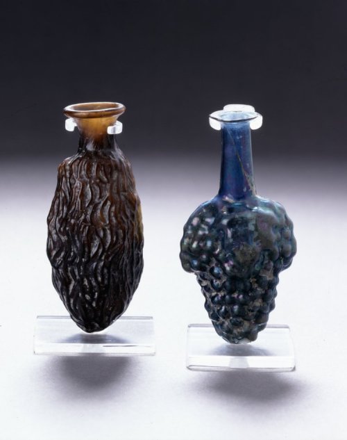 via-appia:Mold-blown glass flasks in the form of a dried grape and a bunch of grapesRoman, 50-150