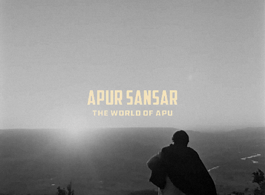 black and white gif of a man standing in from of a sunset. apur sansar is written in yellow in the middle