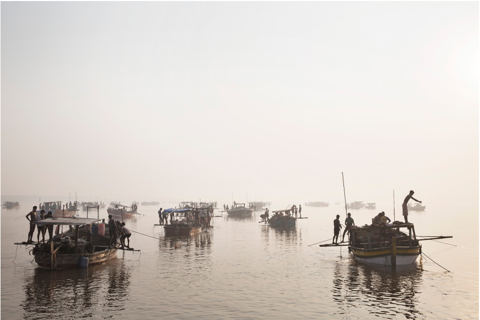 “Sand mining boats work illegally on the Thane Creek in Maharashtra, India, on