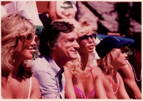 Captured roller skating and talking to friends, Hugh Hefner enjoys his 1979 Playboy Mansion Roller p