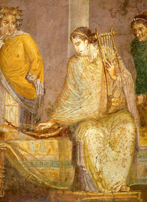 lionofchaeronea:A musician tunes a small harp with her right hand, while holding a cithara in her le