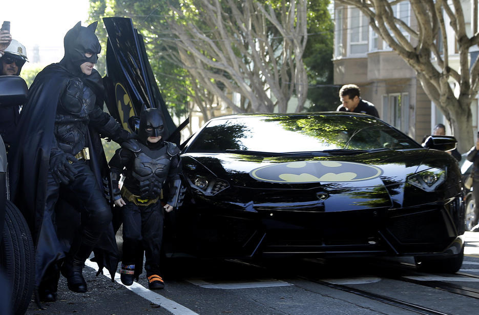 yahoonewsphotos:
“ Batkid wows San Francisco
With the help of the Make-A-Wish Foundation and the city, 5-year-old Miles Scott, aka Batkid, took off from Union Square in the morning in one of two Batmobiles—black Lamborghinis with Batman decals....