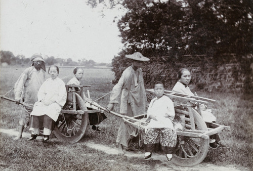 Image 1: Women and a child sitting on a wheelbarrow, an urban transport, in Shanghai, 1907. Referenc