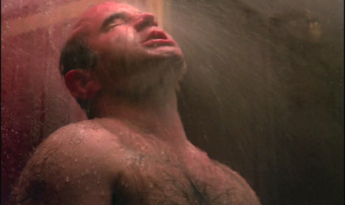 Rugged super-bear Bob Hoskins enjoys a long good shower in The Long Good Friday (1980)