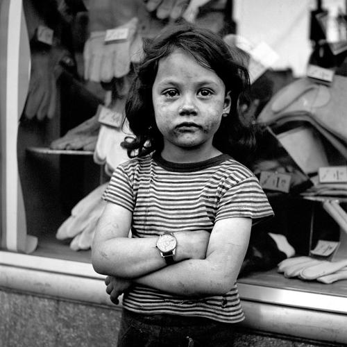 “1950s photo of girl with a soiled face at an unknown location” by Vivian Maier