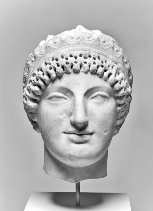 Head of a woman, wearing a diadem; executed in a style mixing Archaizing and Classicizing features. 