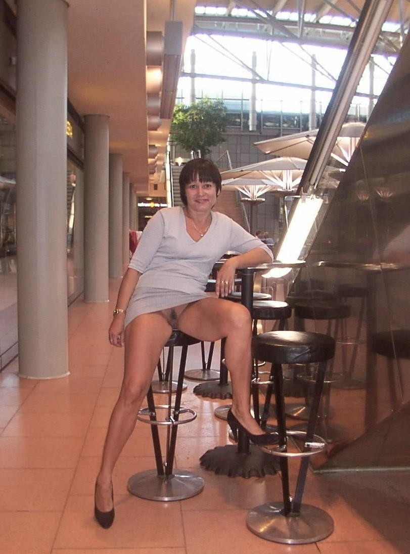carelessinpublic:  Mature lady in a short dress inside a restaurant and showing her