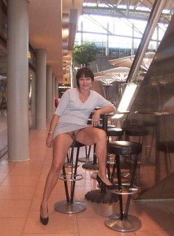 carelessinpublic:  Mature lady in a short dress inside a restaurant and showing her pussy