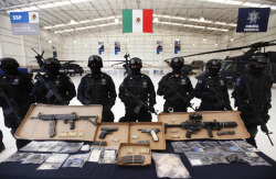 drugwar:  Federal police present weaponry seized during an arrest operation against drug traffickers linked to Chapo Guzman, during a media presentation in Mexico City on February 4, 2012.