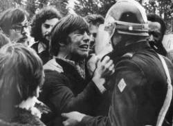 spaceoid:  Two childhood friends unexpectedly reunite on opposite sides of a demonstration in 1972. What a great photograph.   http://www.tumblr.com/follow/spaceoid
