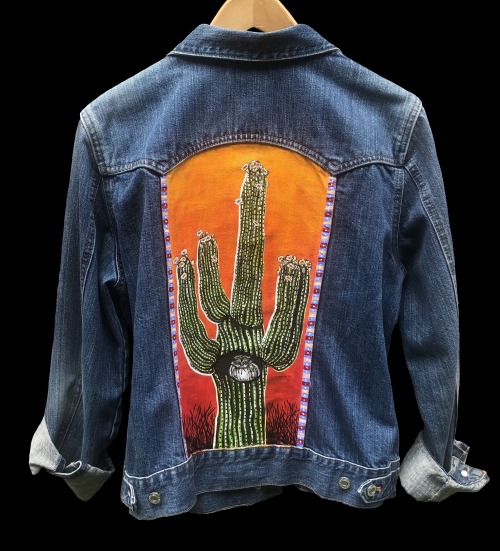 Pygmy owl nesting in a blooming saguaro, hand painted on a Gap jean jacket. Available in my shop: go