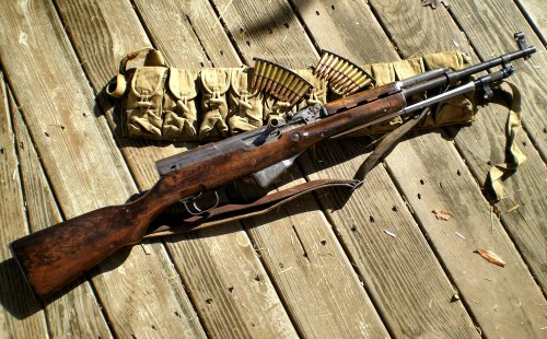 tristikov:  Type 56 SKS (apparently the Chinese copy of the AKM is also a type 56) and bandoleer. Dem high-capacity assault clips too.