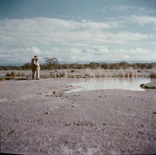  Ernest Hemingway with his arm around Mary Hemingway while hunting during his second African safari.