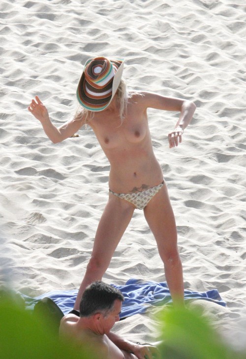 toplessbeachcelebs:  Laeticia Hallyday (Model) swimming topless on the beach (August 2009) 