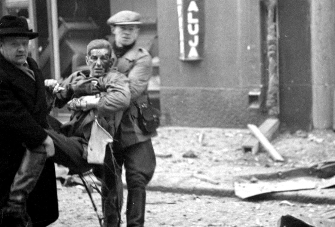 bag-of-dirt:  A wounded Finnish man is carried to safety following a Soviet bombing