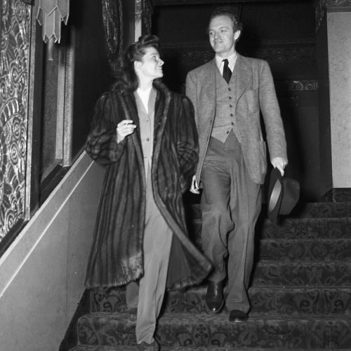 1941- Katharine Hepburn and Van Heflin coming down the balcony steps of the Hollywood Theater after 