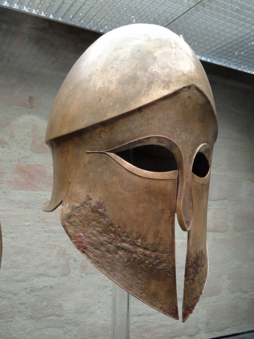 ancientart:Greave and Corinthian helmet from the tomb of Denda. The name of the warrior (Denda) is e