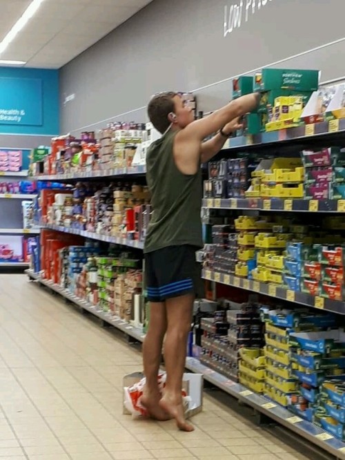 Hot young barefoot man with delicious looking hot feet in the supermarket! 