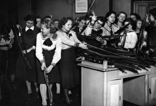 Military training has been introduced to the schools in Budapest. Here the pupils of a girl’s school are issued with their arms, 1939.