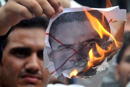 pakistanpeoplesparty: A Pakistani man burning a picture of President Barack Obama, during a protest 